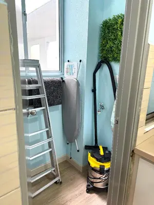 a room with a mop in the corner of a room at Mama King’s Homestay@ Palas Horizon in Brinchang