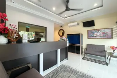 a waiting room with a counter and a chair at OYO 90369 Safari Hotel Lumut in Kampong Pundut