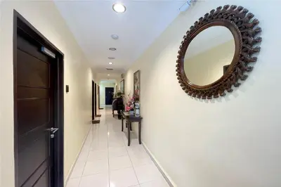 a hallway with a mirror on the wall at OYO 90369 Safari Hotel Lumut in Kampong Pundut