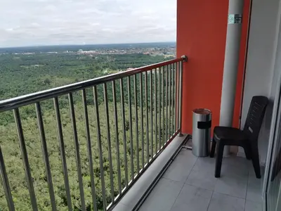 a balcony with a chair and a view of a field at Coco HomeStay \u65c5\u4eba\u306e\u5bb6@The Venus Sitiawan Perak in Sitiawan