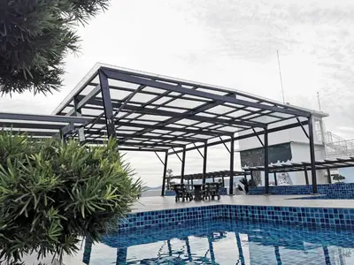 a pavilion over a pool with a table and chairs at Coco HomeStay \u65c5\u4eba\u306e\u5bb6@The Venus Sitiawan Perak in Sitiawan