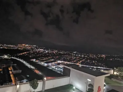 a view of a city at night at Coco HomeStay \u65c5\u4eba\u306e\u5bb6@The Venus Sitiawan Perak in Sitiawan
