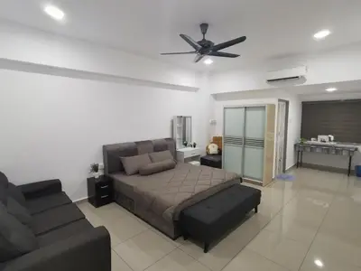 a bedroom with a bed and a couch and a ceiling fan at Coco HomeStay \u65c5\u4eba\u306e\u5bb6@The Venus Sitiawan Perak in Sitiawan