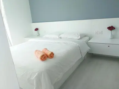 two brown teddy bears sitting on a white bed at Deluxe and Feel like a home 1, 3-6 pax ,Netflix, Georgetown in George Town
