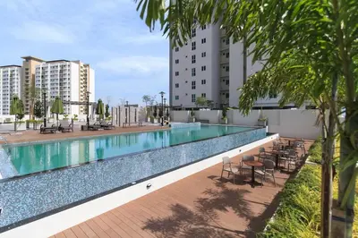 a large swimming pool with chairs and tables on a building at Deluxe and Feel like a home 1, 3-6 pax ,Netflix, Georgetown in George Town