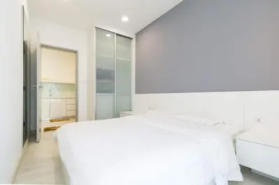 a white bedroom with a large white bed at Deluxe and Feel like a home 1, 3-6 pax ,Netflix, Georgetown in George Town