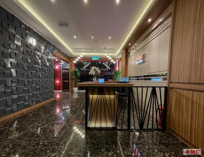 a lobby with a bar in a building at BMC Hotel in Ipoh