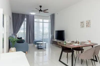 a living room with a dining table and a living room with a tv at Beacon Executive Suite Penang in George Town