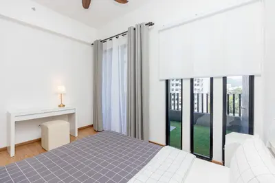 a bedroom with a bed and a large window at Beacon Executive Suite Penang in George Town