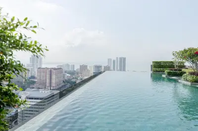 a infinity pool with a city skyline in the background at Beacon Executive Suite Penang in George Town