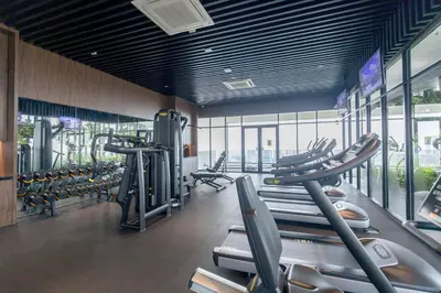 a gym with a row of treadmills and machines at Beacon Executive Suite Penang in George Town