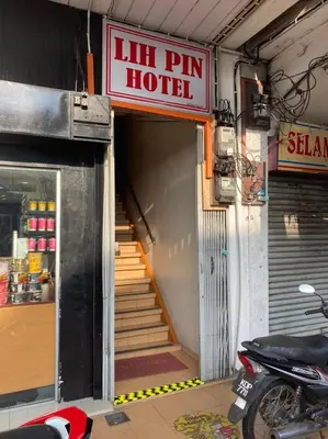 an entrance to a hotel with a stairway and a sign at Lih Pin Hotel in Sungai Petani