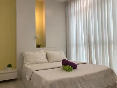 a bedroom with a bed with a pillow on it at Straits Garden Suite Jelutong Georgetown in George Town