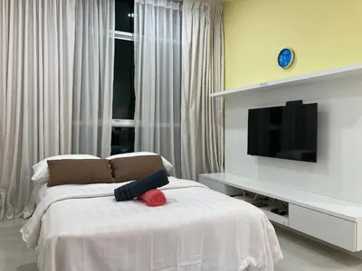 a bedroom with a bed with a television on it at Straits Garden Suite Jelutong Georgetown in George Town