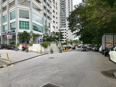 an empty street in a city with cars and buildings at Straits Garden Suite Jelutong Georgetown in George Town