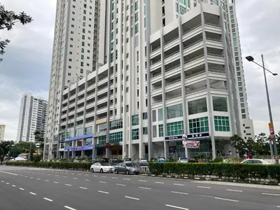 a large building with cars parked in front of a street at Straits Garden Suite Jelutong Georgetown in George Town