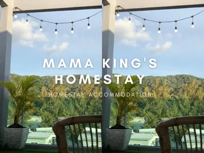 a view of a house from a porch with lights and palm trees at Mama King's Homestay @ Marina Island in Kampong Batu Gajah