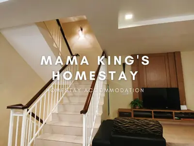 a living room with a staircase with a tv at Mama King's Homestay @ Marina Island in Kampong Batu Gajah