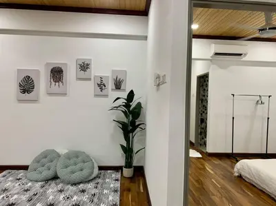 a bedroom with a bed and a plant in a room at The Venus - Spacious Wooden TOP Floor Apartment in Sitiawan