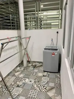 a bathroom with a tile floor with a trash can at The Venus - Spacious Wooden TOP Floor Apartment in Sitiawan