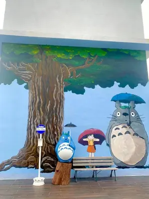 a mural of a tree and a woman with umbrellas at The Venus - Spacious Wooden TOP Floor Apartment in Sitiawan