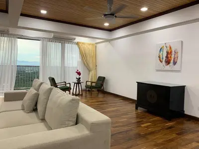 a living room with a couch and a television at The Venus - Spacious Wooden TOP Floor Apartment in Sitiawan