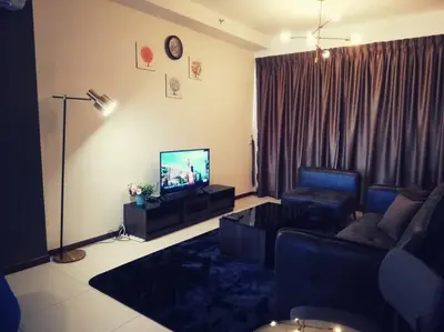 a living room with a couch and a flat screen tv at Landmark By Katana 3BR Glamorous Highrise Seaview Homestay Gurney\u65e0\u654c\u6d77\u666f\u4e09\u623f\u5957\u623f in Tanjong Tokong