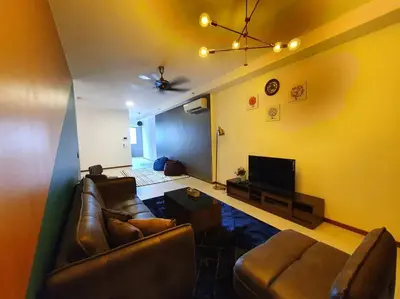 a living room with two leather couches and a tv at Landmark By Katana 3BR Glamorous Highrise Seaview Homestay Gurney\u65e0\u654c\u6d77\u666f\u4e09\u623f\u5957\u623f in Tanjong Tokong