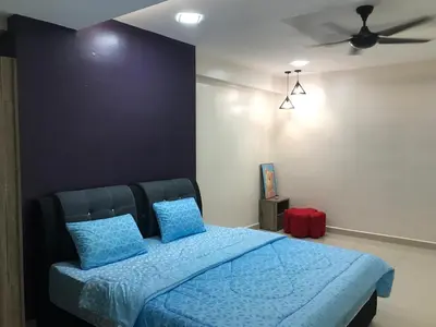 a bedroom with a blue bed with a ceiling fan at WL Homestay in Sitiawan