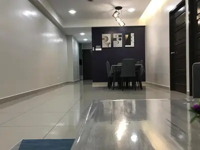 a dining room with a table and chairs at WL Homestay in Sitiawan