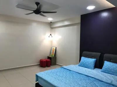 a bedroom with a blue bed and a ceiling fan at WL Homestay in Sitiawan