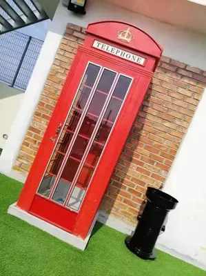 a red door on the side of a brick building at WL Homestay in Sitiawan