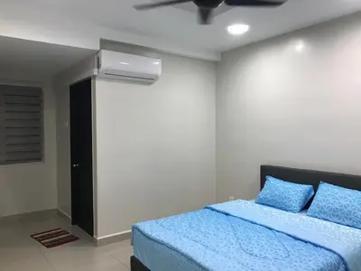 a bedroom with a bed and a ceiling fan at WL Homestay in Sitiawan