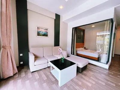 a living room with a couch and a bed at Nova Apartments near Kea Farm in Brinchang