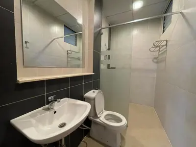 a bathroom with a sink and a toilet and a mirror at Nova Apartments near Kea Farm in Brinchang