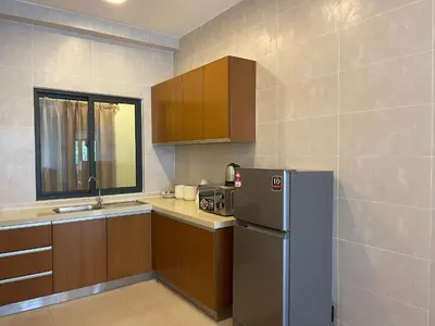 a kitchen with a refrigerator and a sink at Nova Apartments near Kea Farm in Brinchang