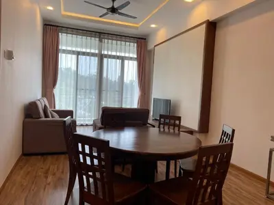a living room with a table and chairs and a couch at Nova Apartments near Kea Farm in Brinchang
