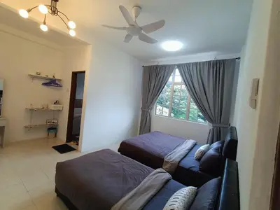 a living room with two beds and a ceiling fan at Dream 1 in Cameron Highlands