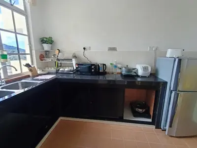 a kitchen with a black counter and a refrigerator at Dream 1 in Cameron Highlands