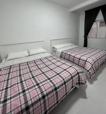 two beds sitting next to each other in a bedroom at Cameron Emerald Avenue 2 @ Brinchang in Brinchang
