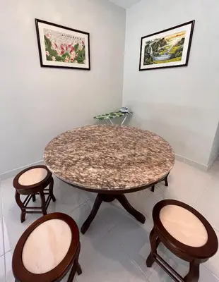 a table with two chairs and a table with a marble top at Cameron Emerald Avenue 2 @ Brinchang in Brinchang