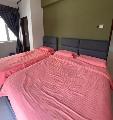 two beds in a room with pink sheets at Cameron Emerald Avenue 2 @ Brinchang in Brinchang