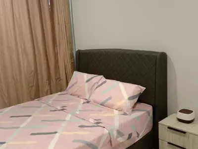 a bedroom with a bed with a pillow and a night stand at QC Homestay - Room Only in Pusing