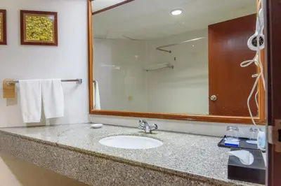 a bathroom with a sink and a mirror at J Beach Suites At Rainbow Paradise in Tanjung Bungah