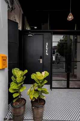 two potted plants sitting in front of a door at Chulia Heritage Studio in George Town