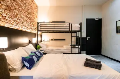 two beds in a room with two bunk beds at Chulia Heritage Studio in George Town
