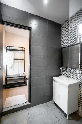 a bathroom with a mirror and a sink and a shower at Chulia Heritage Studio in George Town