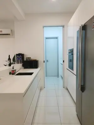 a kitchen with white counters and a refrigerator at Jazz Suites Apartment Penang By Jazz Service Suite in Bagan Jermal