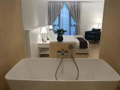 a bathroom with a bath tub in a hotel room at Jazz Suites Apartment Penang By Jazz Service Suite in Bagan Jermal