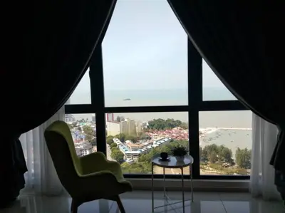 a room with a large window with a table and chairs at Jazz Suites Apartment Penang By Jazz Service Suite in Bagan Jermal